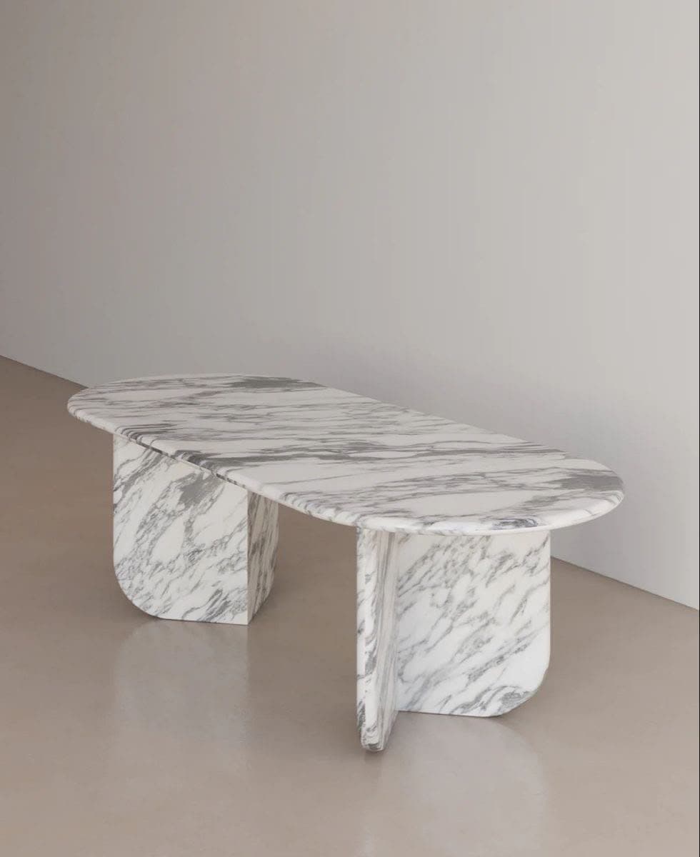 Table ovale en marbre blanc veiné de gris, posée sur deux piétements pleins